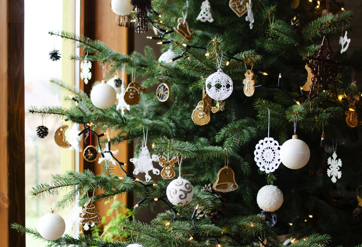 Christmas decoration hanging on christmas tree near window at home. New Year card.