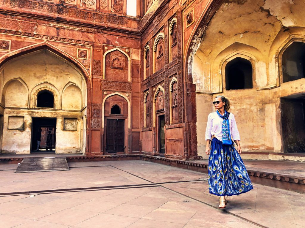 Full Length Of Woman Walking Against Historic Building