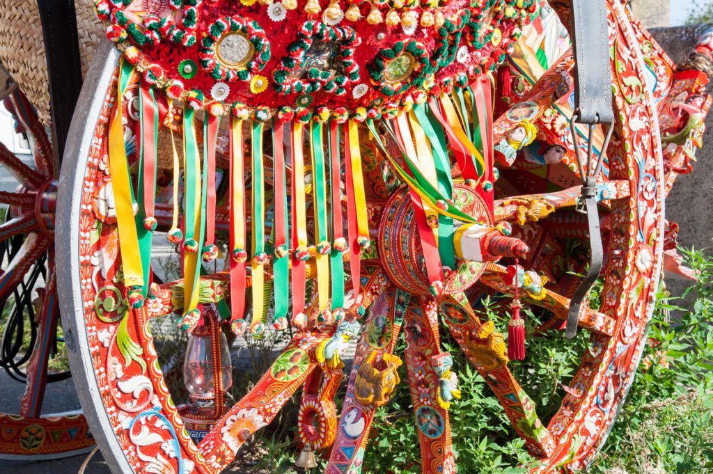Close up view of a colorful harness of a typical sicilian cart during a folk festival